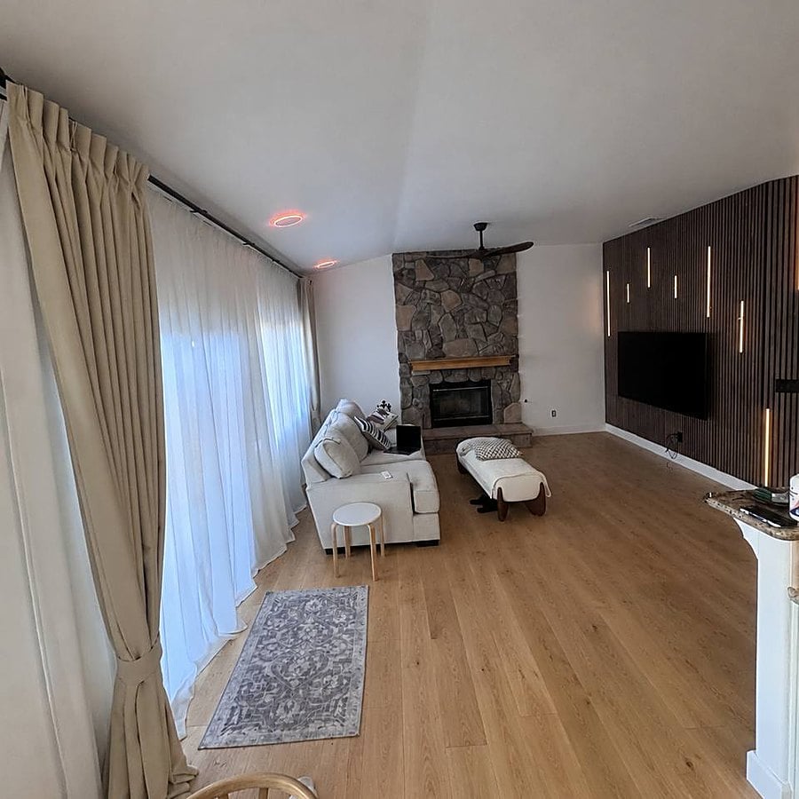 Freshly painted living room with a lit slat feature wall